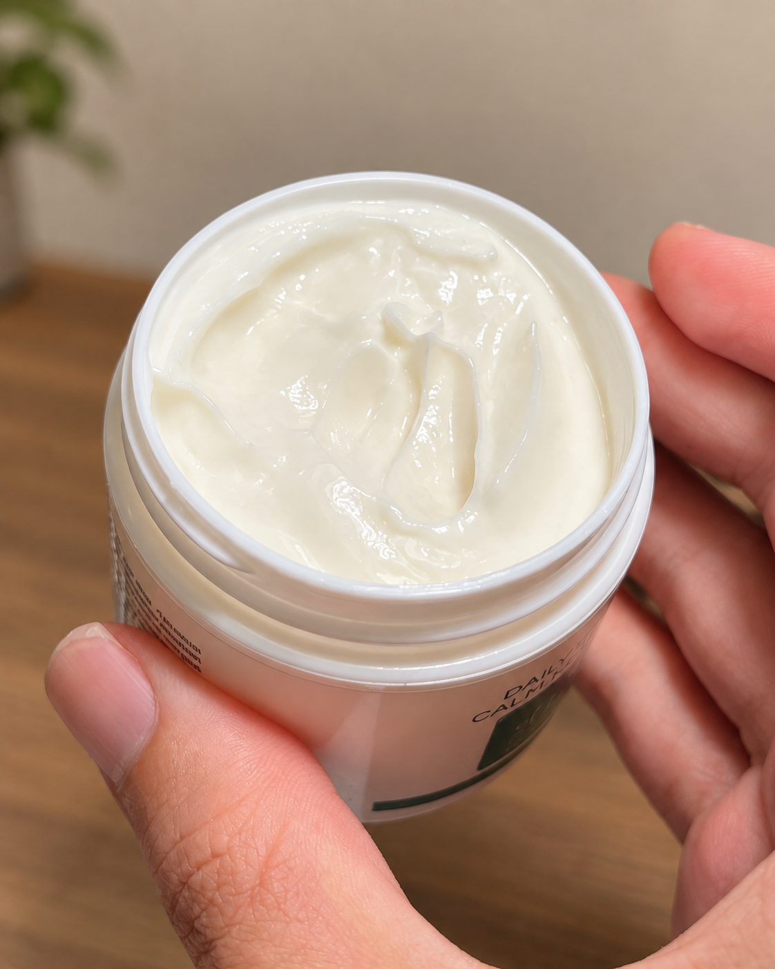 Open Daily Repair & Calm jar showing buttery-rich creme texture